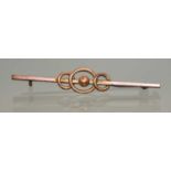 A 9ct gold bar brooch of triple loop design, with beaded centre, approximately 56mm long, 1.98g.
