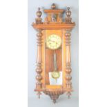 A late 19th century mahogany cased Vienna style wall clock with half turned pillars, 89cms tall