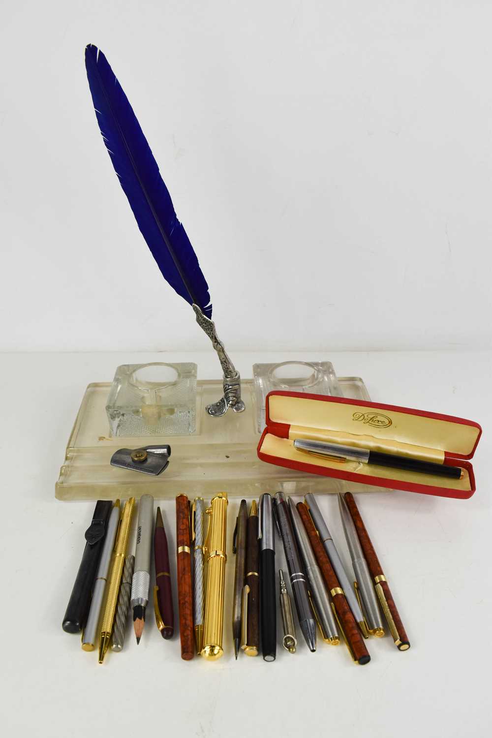 A 1950s pressed glass inkstand, a quil and stand, and a group of pens and propelling pencils, to