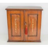 A Victorian mahogany wall cabinet with later inscription, Purdey, Gun and Cartridge makers.