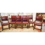 A set of six oak and red leather dining chairs including two carvers. 101cms tall by 53cms wide by