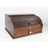 A 19th century mahogany roll top stationary box, the tambour slide opens to reveal a fitted