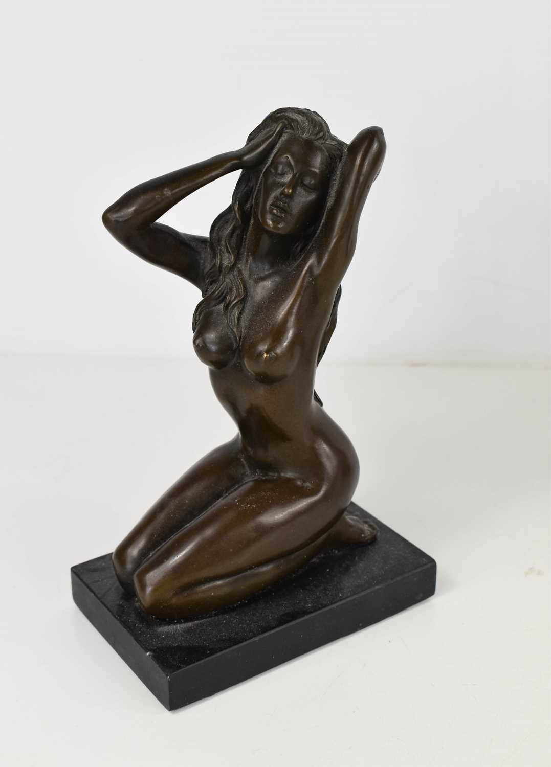 Milo bronze figure of a nude woman raised on slate base, 21cm high.