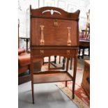 An Arts & Crafts Liberty style slim fall front bureau with copper hinges and handles.