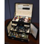 A jewellery box containing various costume jewellery, including beaded necklaces and bracelets.