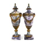 A pair of early 20th century French Blue John style amethyst/quartz and ormolu urns, the upper