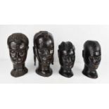 Four carved ebony heads, mid 20th century, representing the four Tribes of Sierra, largest 25cm