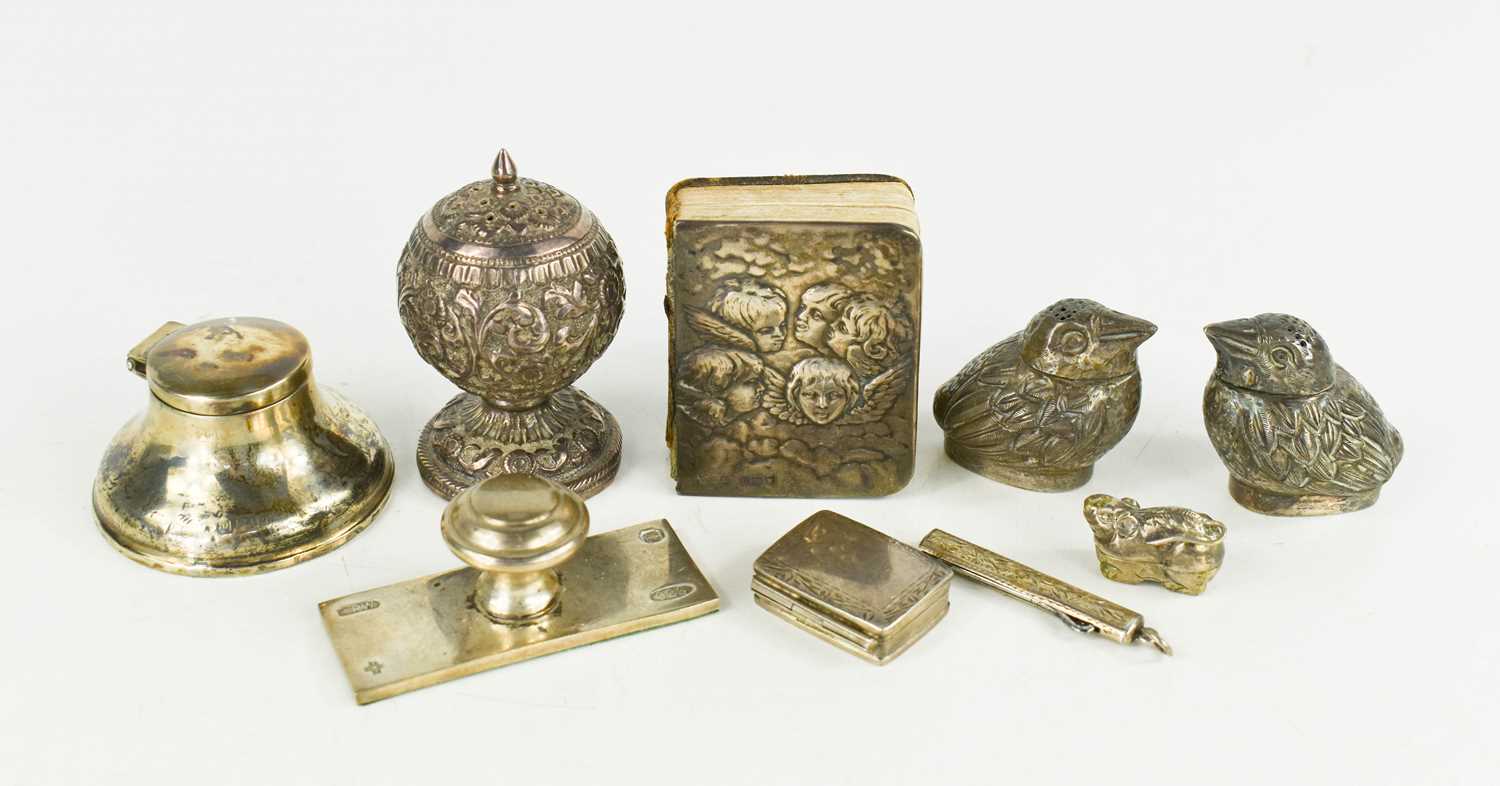 A group of silver collectables to include a salt and pepper in the form of birds, inkwell, Book of