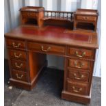 An Edwardian mahogany desk, with raised back containing drawers, and two banks of drawers.