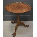 A 19th century tripod table with pie crust top, and turned column supported by three cabriole legs