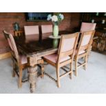 An oak dining table, with cup and cover carved legs, extra leaf and winder, together with a set of