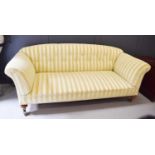 A Victorian cream upholstered settee, with button back, and raised on castors, 205cms long by