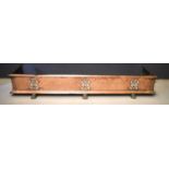 A Victorian copper fire fender with pierced decorative panels and raised on paw feet, 136cm.