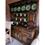 An 18th century style oak dresser and rack, the rack having a pierced and shaped apron, above thre