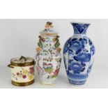 A Chinese blue and white baluster form vase, a polychrome vase and cover, and a pottery biscuit