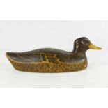 A wooden carved decoy duck, hand painted with 'naive' finish, 34cm long.