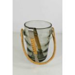 A Holmgaard smoky glass mid century ice bucket, with rattan handle and matching brushed steel pair