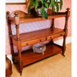 A Victorian mahogany three tier buffet, with shaped back and the middle shelf having two drawers,