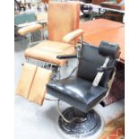 Two barber's chairs, one with tan leatherette, adjustable leg and arm rests, on circular swivel