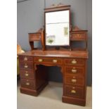 An Edwardian mahogany inlaid dressing table, with mirror back, flanked by two small cupboards, the