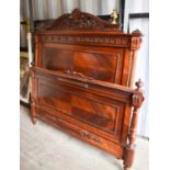 An Edwardian mahogany French bed head and end board, the crested top carved with scrollwork, and