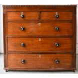 A 19th century oak chest of drawers, the two over three long graduated drawers having turned