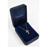 A Tiffany & Co 18ct gold necklace with Elsa Perretti designed cross pendant, 4.3g.