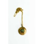A 9ct gold necklace and flower form pendant set with green seed pearls, 4.3g
