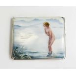 A silver and enamel cigarette case with a nude girl bathing in the sea with mountains in the
