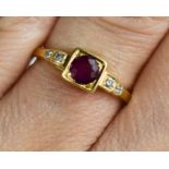 An 18ct gold brilliant cut ruby, with step shoulders, diamond set, size K, 2.58g.