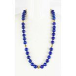 An 18ct gold and lapiz lazuli beaded necklace, with 18ct gold extension chain, beads and clasp, 92g,