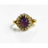 An 18ct gold, diamond and amethyst ring, the oval cut amethyst surrounded by a border of diamonds,