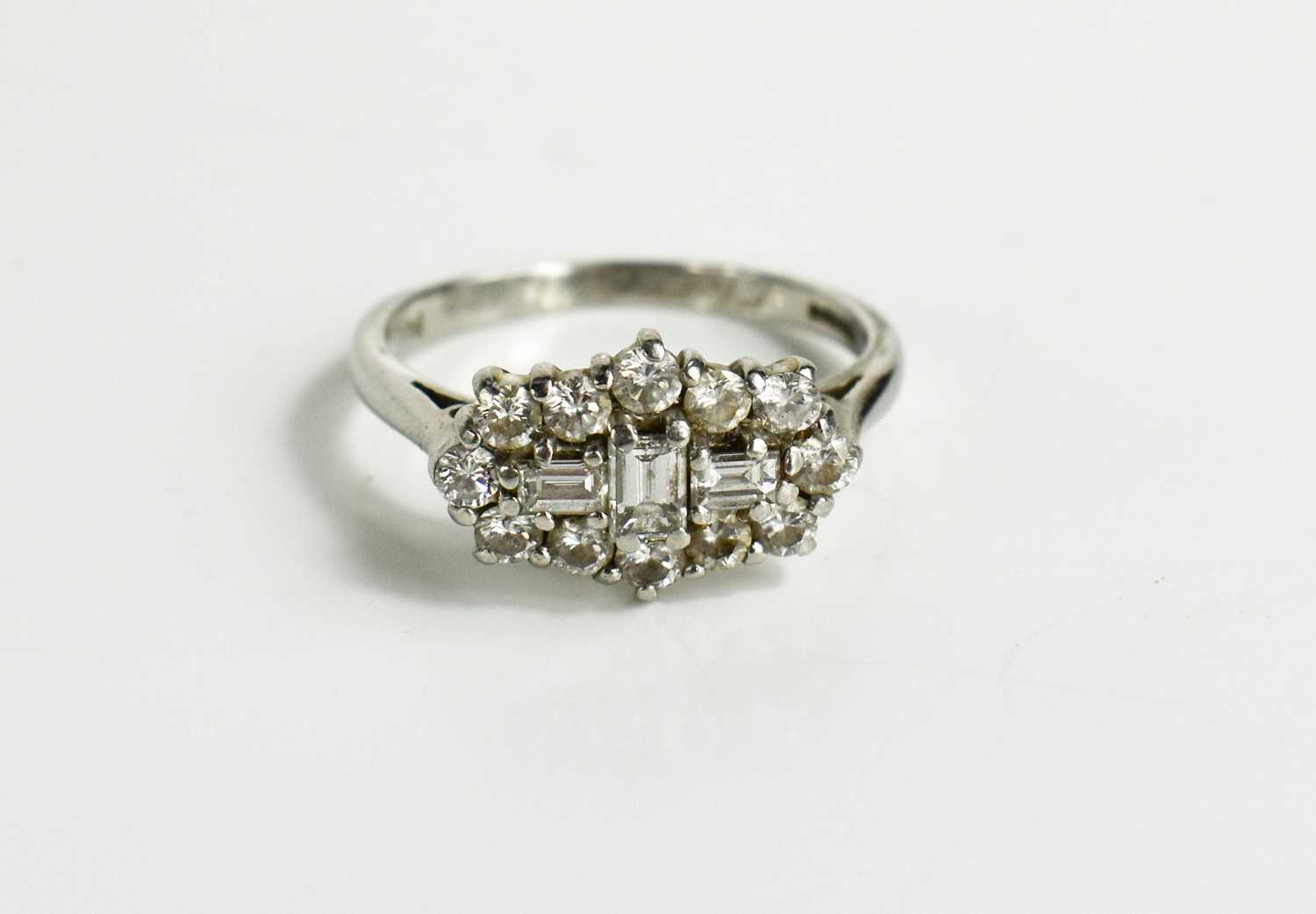 A platinum and diamond cluster ring, by Dawson of Stamford, the three baguette cut diamonds to the - Bild 5 aus 8