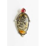 A silver, garnet, seed pearl and moss agate pendant, the oval moss agate set beneath a pear shaped