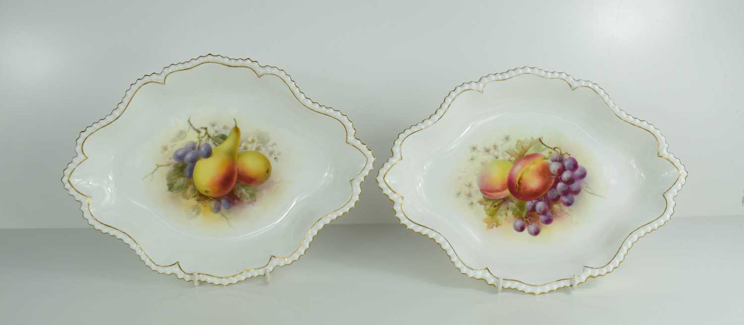 A pair of Royal Worcester lozenge shape dishes by F Roberts, painted with fruit, puce mark circa