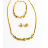 A 22ct gold Indian necklace and bracelet set with paste, together with a pair of 22ct gold