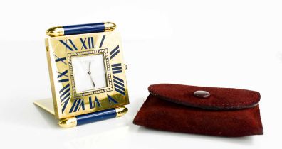 A Cartier travel clock, Quartz, reg no. 355105836, in the original velvet maroon pouch.