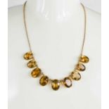 A 9ct gold and citrine necklace, with graduated oval cut citrines, likely Victorian, largest stone