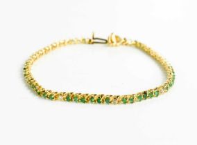 A 14ct yellow gold, diamond and emerald set bracelet, 7g.
