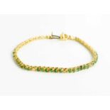 A 14ct yellow gold, diamond and emerald set bracelet, 7g.