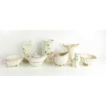 A group of Belleek pottery to include a teapot, sugar bowl, milk jug, vases and a cat.