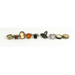 A selection of nine various dress rings, including one set with garnet cabochons.