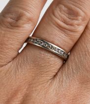 An 18ct white gold and half hoop diamond eternity ring, the channel set front containing a total