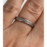 An 18ct white gold and half hoop diamond eternity ring, the channel set front containing a total