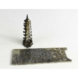 A Chinese silver pagoda, 0.9tox, 9.5cm high, together with a white metal plaque modelled with