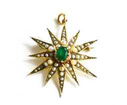 An Edwardian 9ct gold, emerald and seed pearl starburst pendant / brooch, the oval emerald