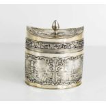 A Dutch silver tea canister, the lid having a pointed finial and embossed with a milk maid and her
