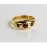 A 9ct gold, garnet three stone antique style ring, size S, 3.8g.