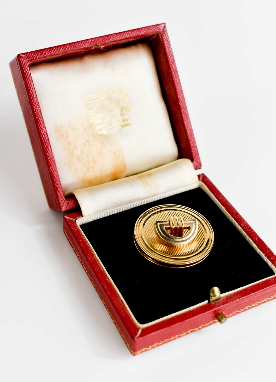 A 9ct gold pill box and lid, by Cartier, the box and lid stamped 375, and initialled, in the