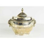 A Regency silver caddy and cover of oval form, the cover having an acorn finial, the body having